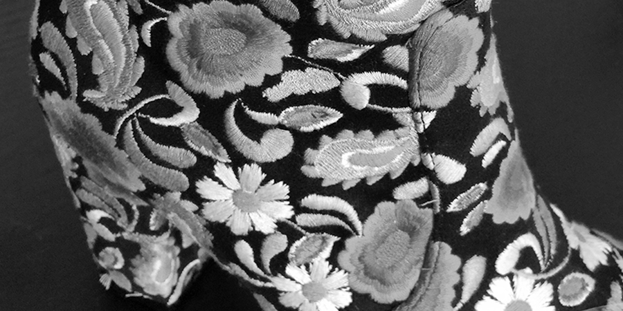 Embroidered floral panel on a sheepskin boot